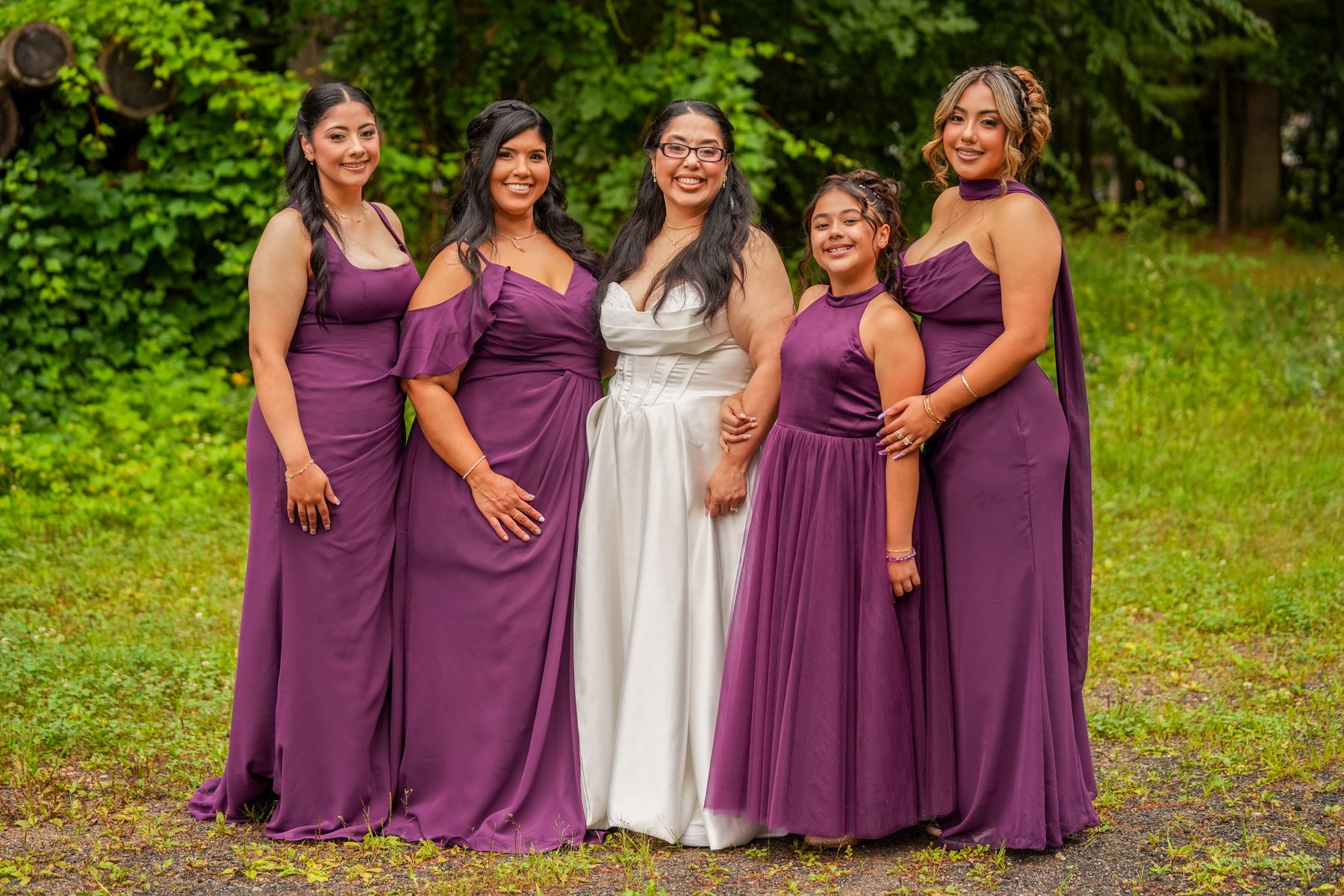 Bride with her bridesmaids and flower girl in purple dresses at a Western Massachusetts wedding