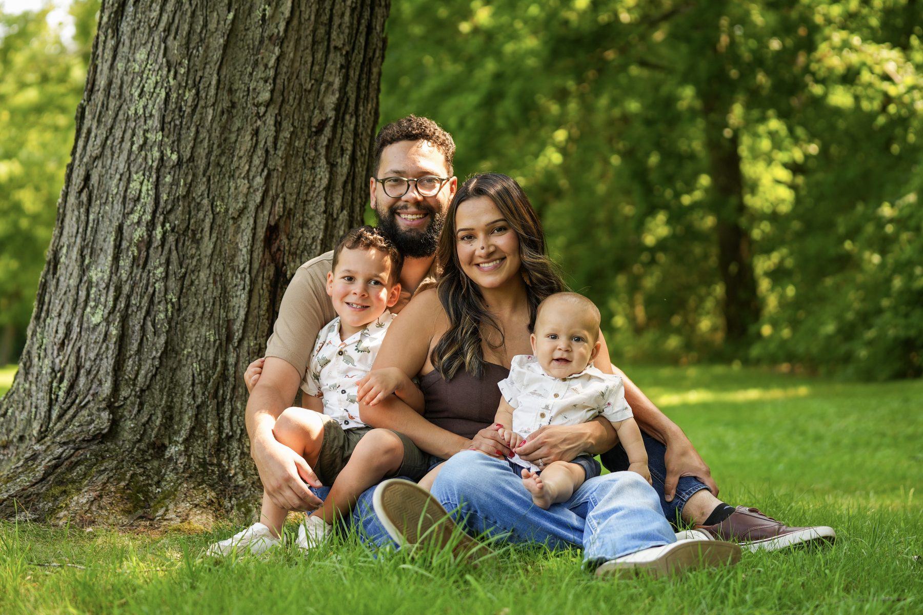 Fall family portrait session with two young children photographed under a tree in West Springfield, Massachusetts
