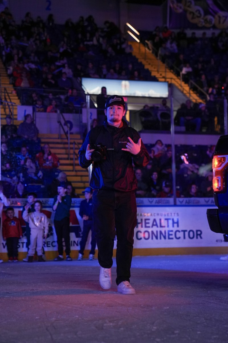 Nolan Lessard walking onto the ice at the MassMutual Center with his camera during a Springfield Thunderbirds game