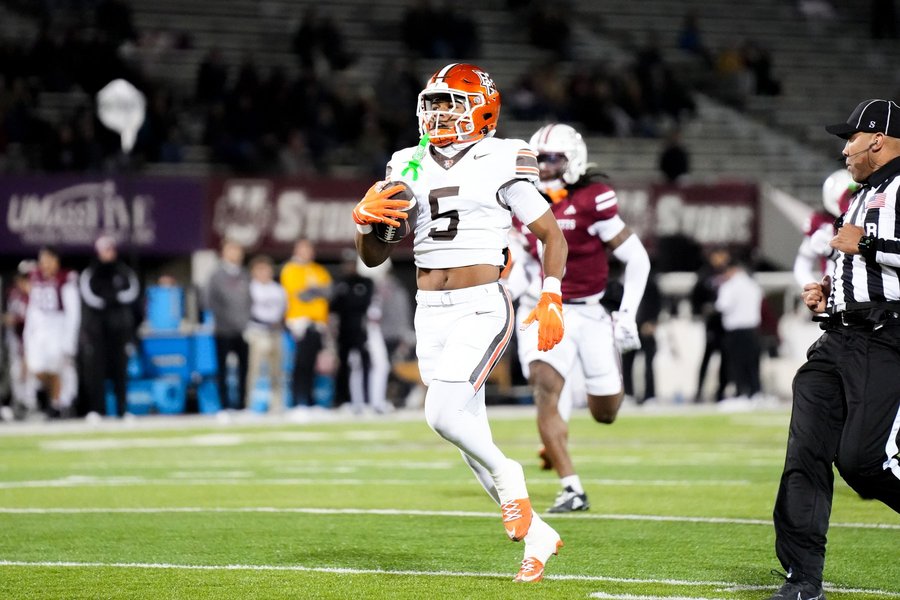 Football running back on a breakaway run during a college game in Massachusetts