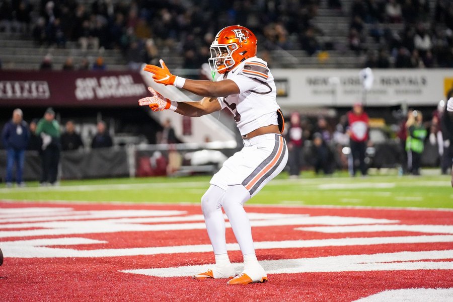 Football player celebrating a touchdown in the end zone