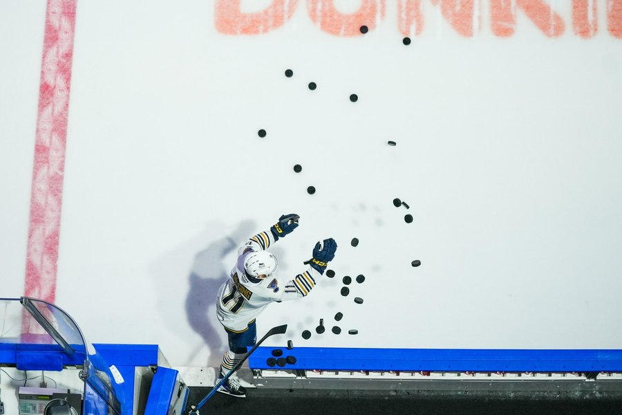 Hockey player tossing a puck to fans before a Springfield Thunderbirds game