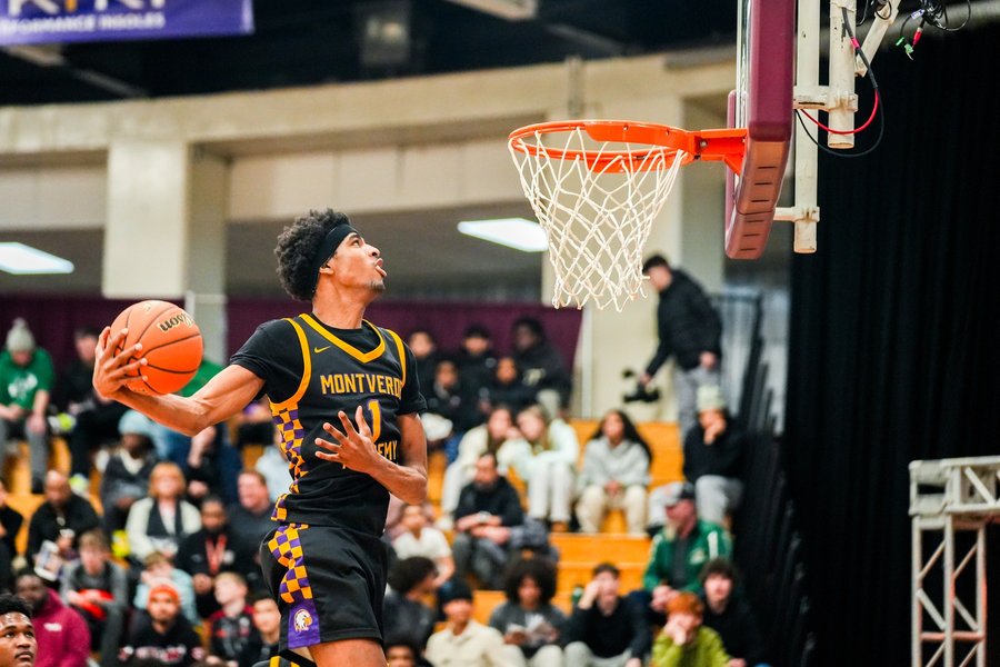 High school basketball player finishing a reverse dunk at the Hoophall Classic in Springfield, MA
