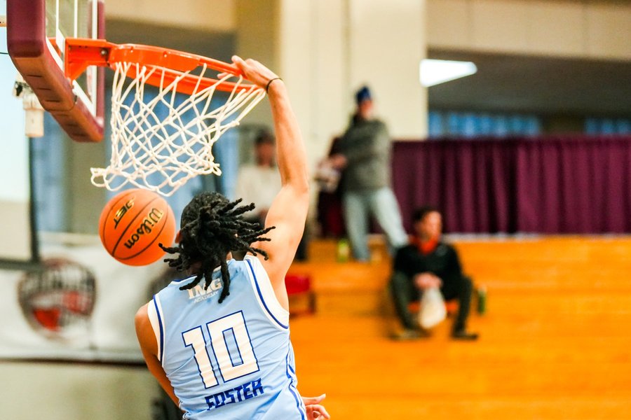 Basketball player flushing a one-handed dunk at the Hoophall Classic