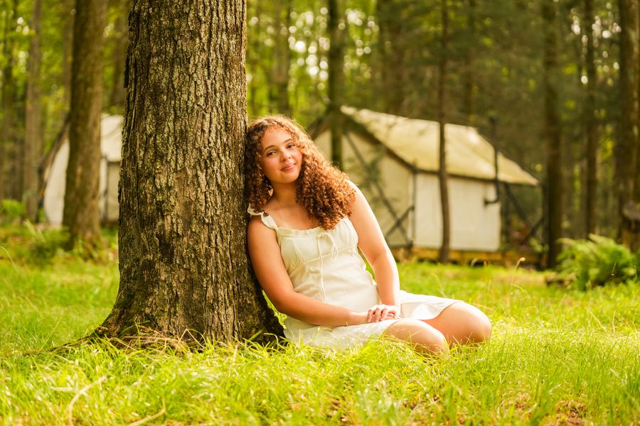 High school senior portrait session in a glamping forest setting in Western Massachusetts