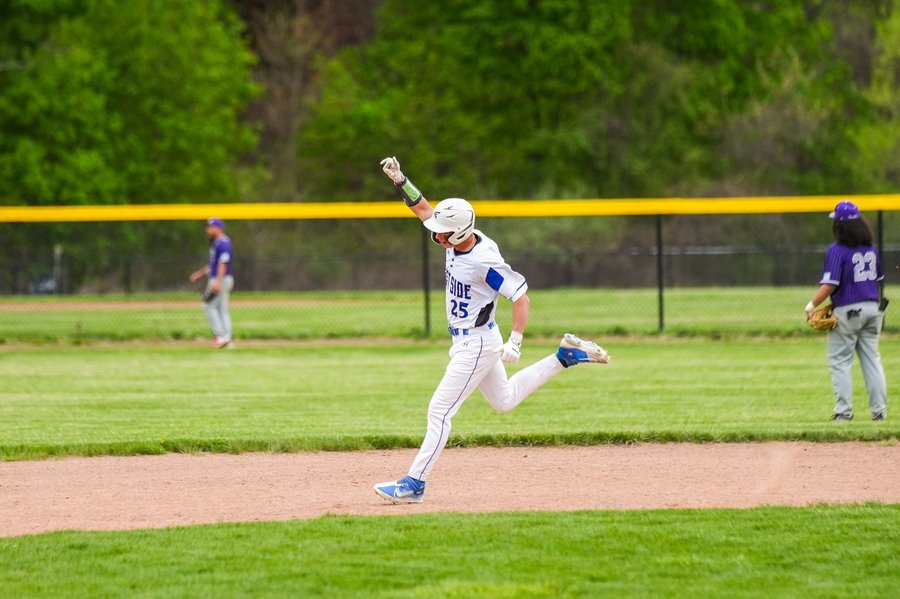West Springfield baseball player celebrating a home run and rounding the bases