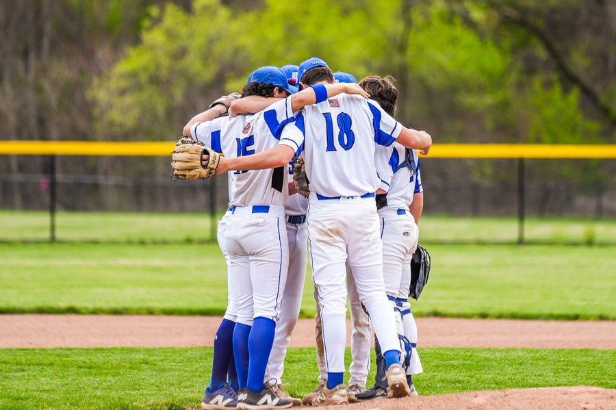 West Springfield high school baseball team huddling on the pitcher's mound